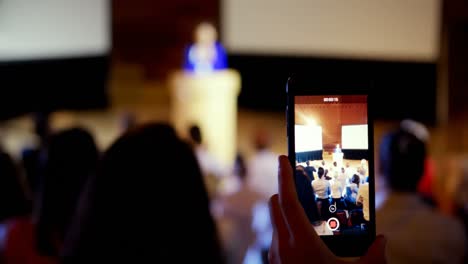 businesswoman recording lecture during business seminar in auditorium 4k