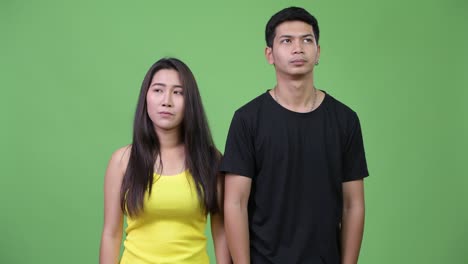 young asian couple looking bored together