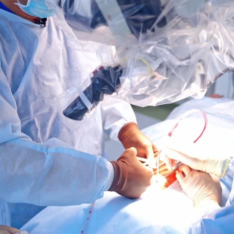 group of doctors perform an operation to a patient. surgeons in medical uniform and masks working in the operating room