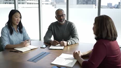 engaging discussion among colleagues in a modern office setting with natural light, emphasizing collaboration and idea exchange in a professional environment