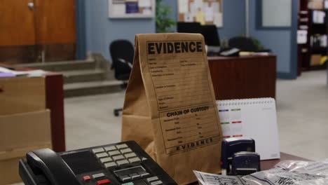 police officer walking past evidence bag in precinct