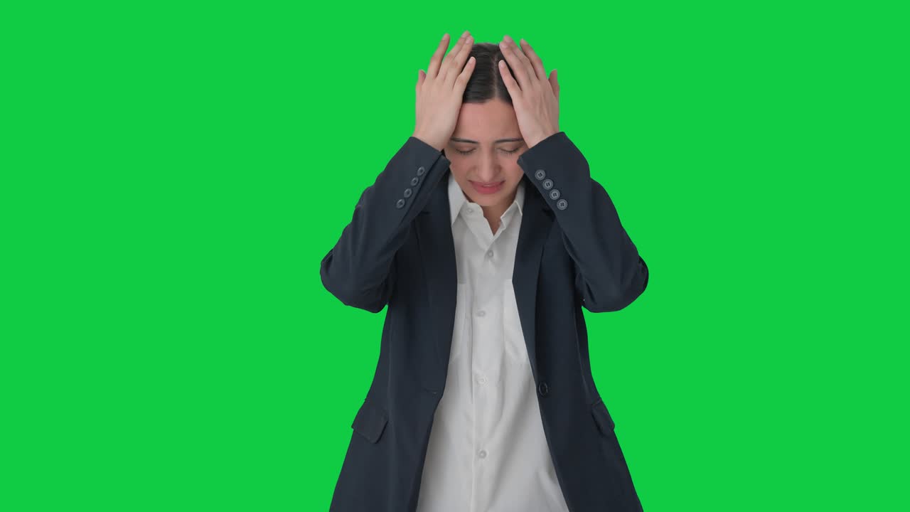 Disappointed Indian female manager slapping her head Green screen