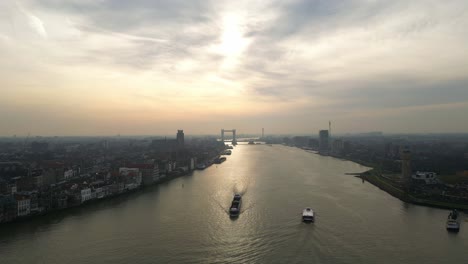 From-high-above,-the-tranquil-beauty-of-the-New-Hampshire-Dordrecht-freight-channel-at-sunset,-vibrant-colors-of-the-setting-sun-cast-a-beautiful-glow-over-the-water