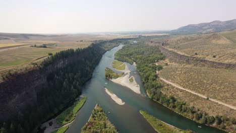 aerial view of river with natural landscape from above in idaho