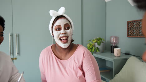 wearing face masks and laughing, friends gathered for cozy celebration together
