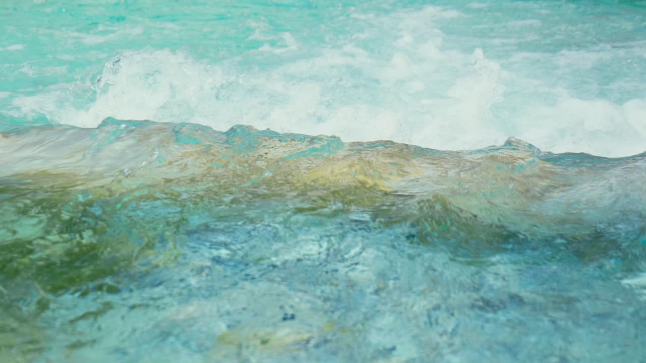 Immerse yourself in the pristine beauty of the Julian Alps with this stunning capture of a mountain river near Kranjska Gora, Slovenia. Crystal-clear turquoise water flows over smooth river rocks.
