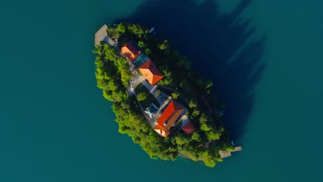 drone view looking down onto lake bled island on a wonderful sunny day - bled, slovenia