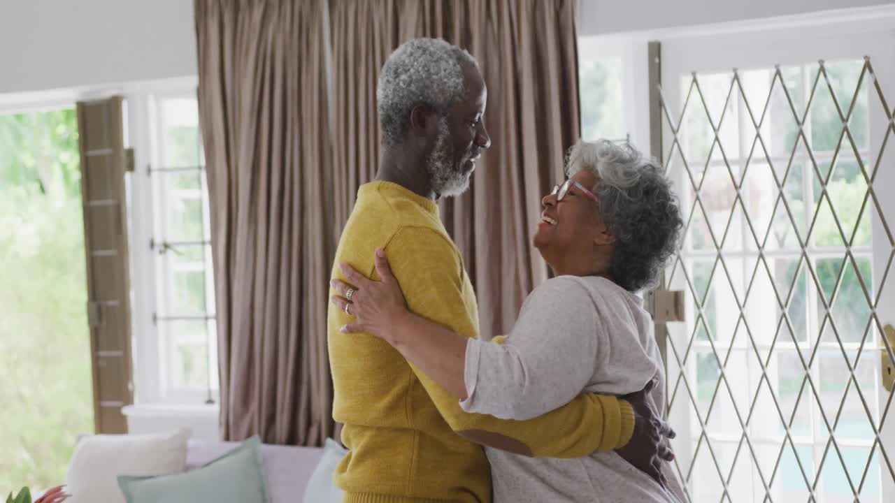 A senior African american couple dancing at home. Social distancing in quarantine