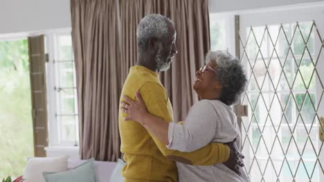 a senior african american couple dancing at home. social distancing in quarantine