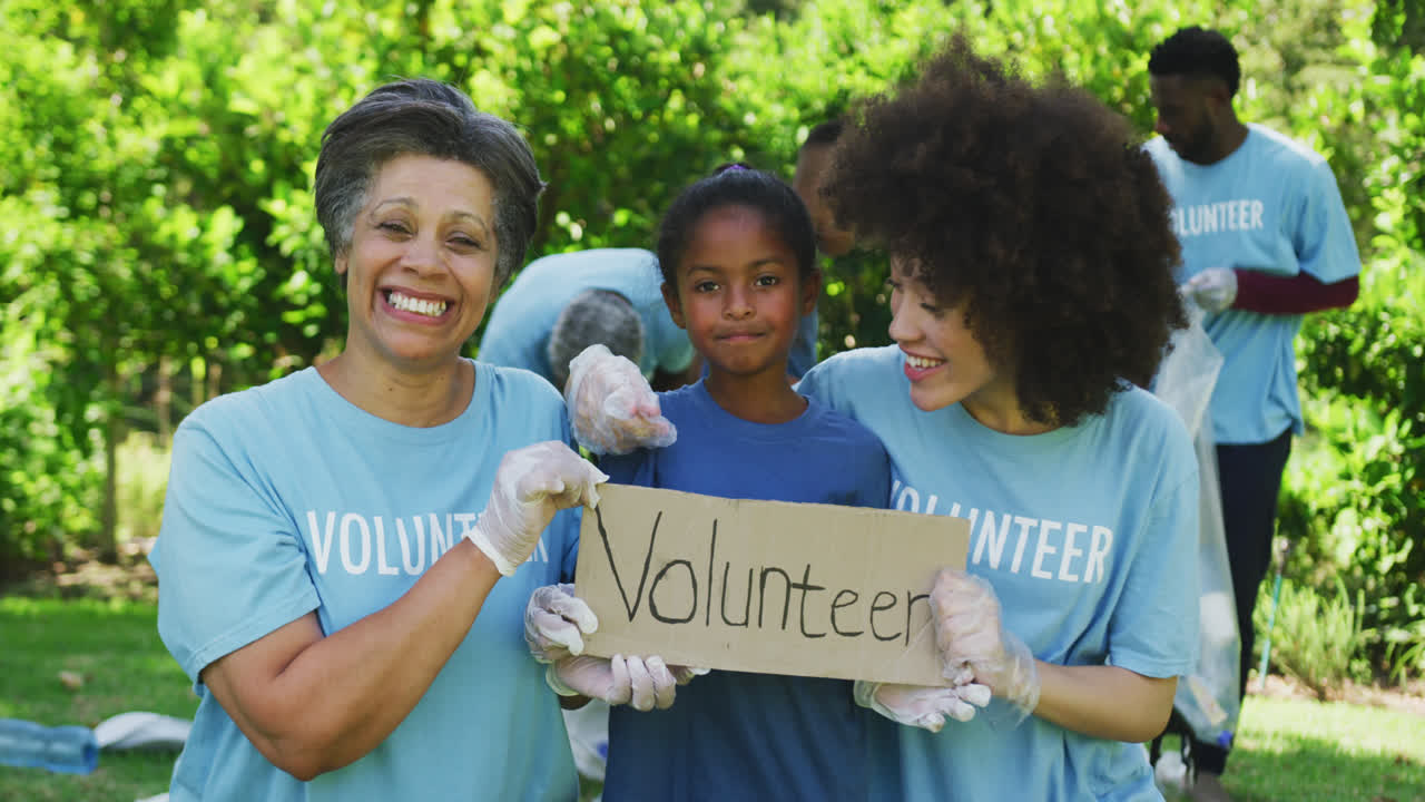 Happy family cleaning a garden together