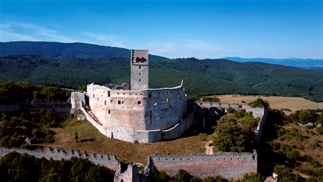 flying around abandoned ruined castle in hills.