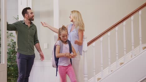 caucasian family entering the front door of their house