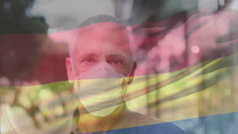 animación de agitar la bandera de alemania sobre el retrato de un hombre caucásico con máscara facial en la calle