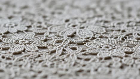 intricate floral lace design showcasing delicate textures and patterns in close-up imagery, highlighting the artistry of textile craftsmanship over two frames
