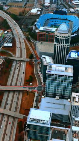 cityscape of american city of charlotte in north carolina. wide lane highway leading to city center. top view. vertical video