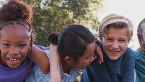 portrait of multi-cultural children hanging out with friends in countryside together