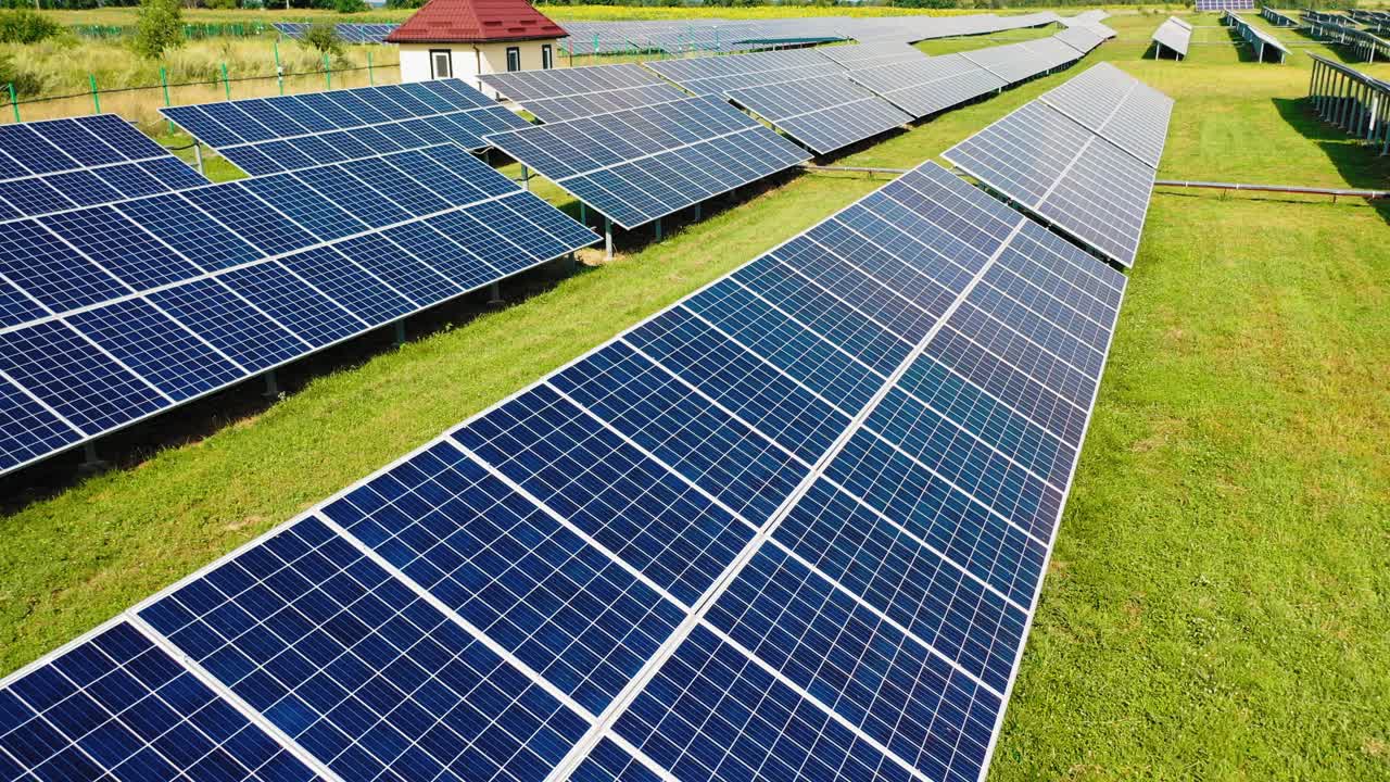 Aerial view of solar energy panels on the natural background. Low flight over solar panels. Contemporary eco energy plant.