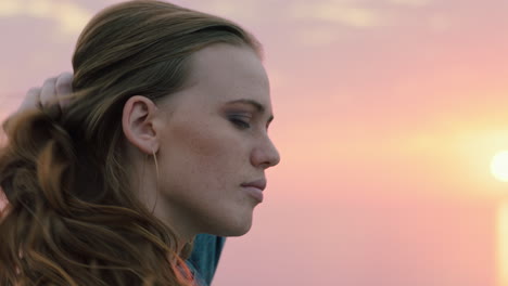 portrait of beautiful young woman enjoying peaceful seaside at sunset exploring spirituality contemplating future