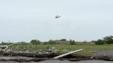 floatplane flying over field in alaska at daytime