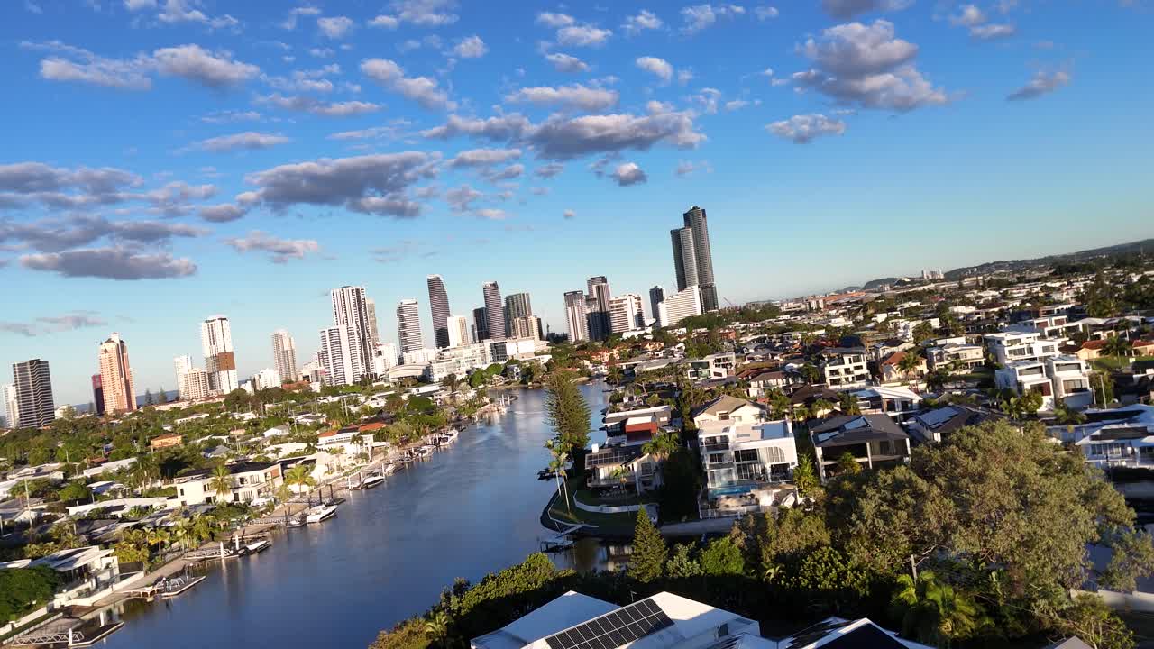 Aerial views of Gold Coast skyline and waterways during sunset, showcasing urban and natural landscapes with dynamic camera movement
