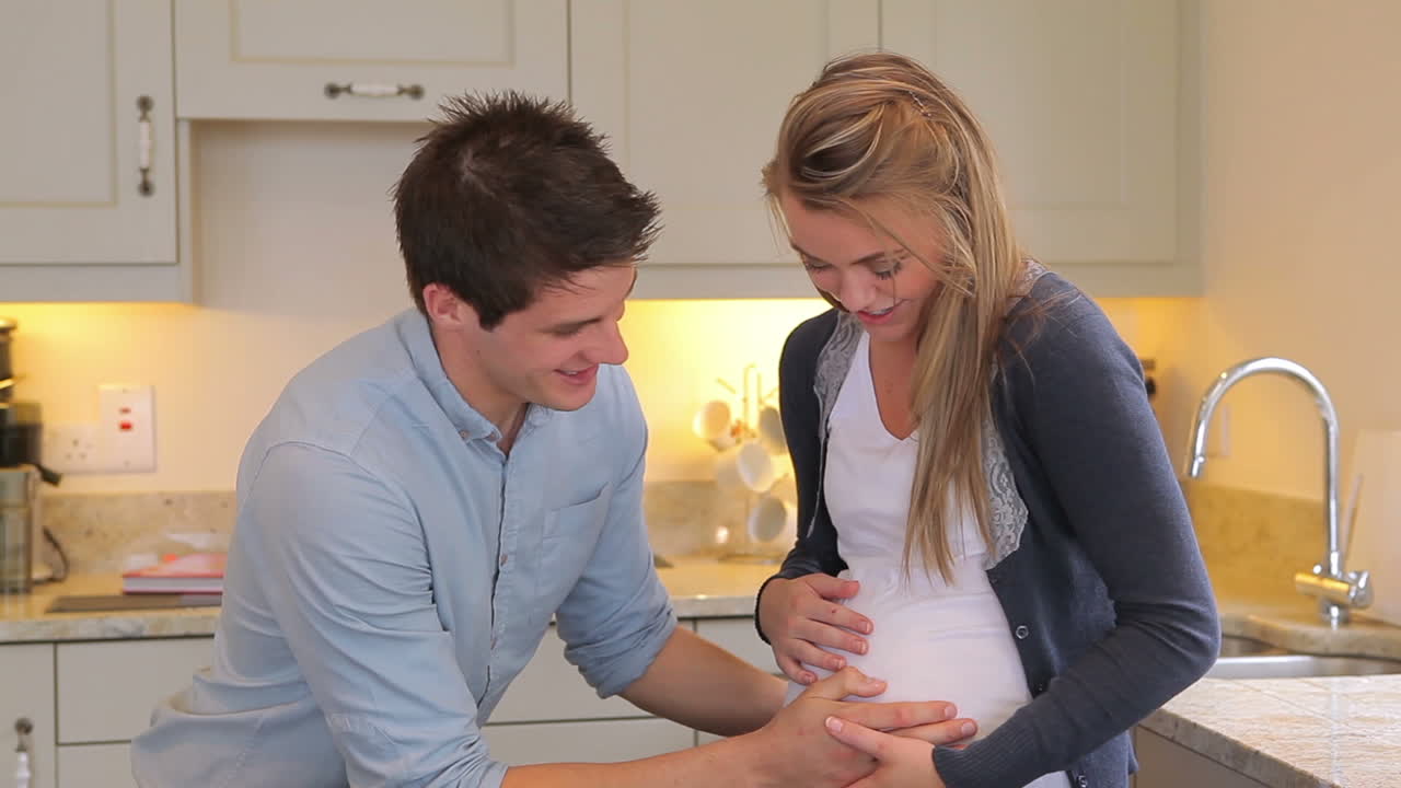 Man touching belly of pregnant girlfriend