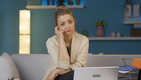home office worker woman thinking looking at camera.