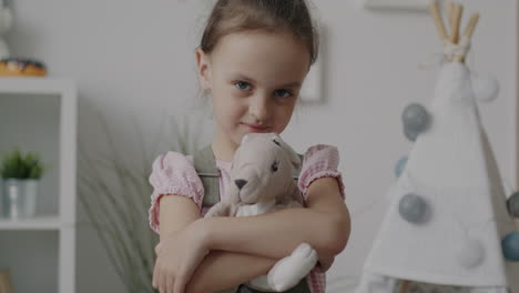 girl with a stuffed rabbit toy