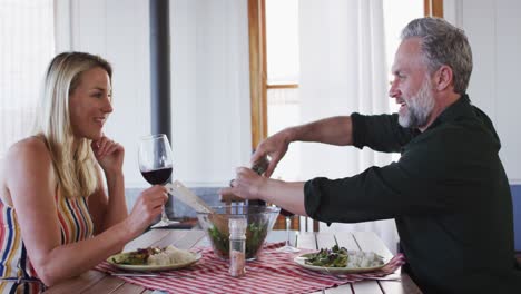Happy-caucasian-mature-couple-smiling,-talking-and-enjoying-meal-together