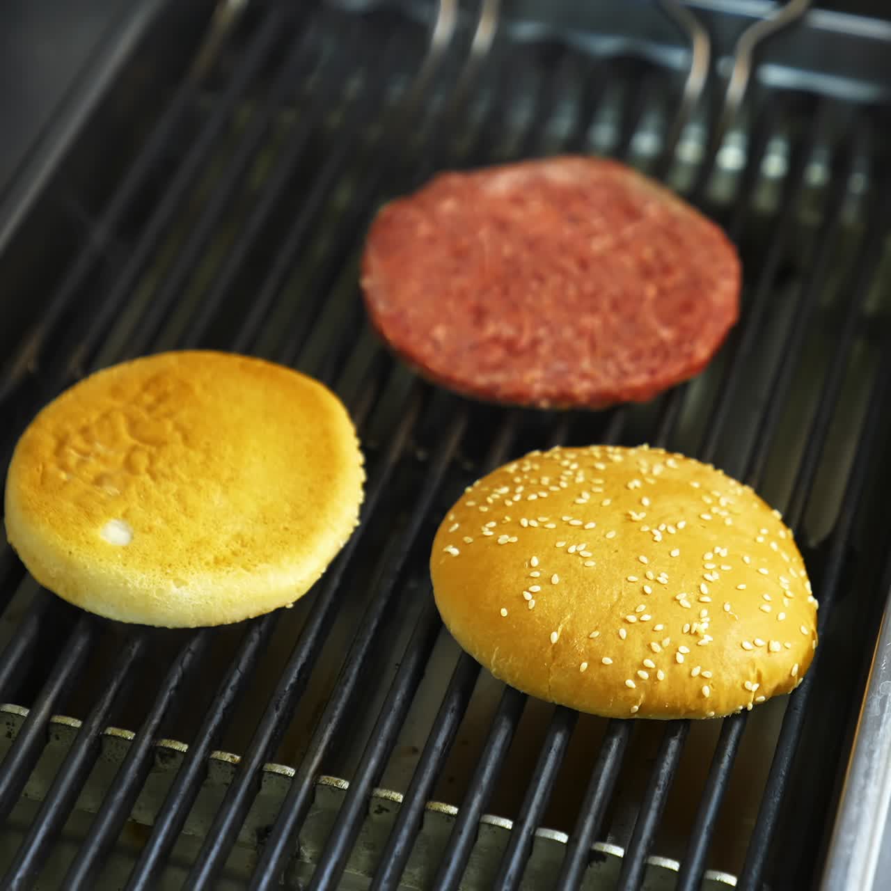 Chef preparing burgers at kitchen