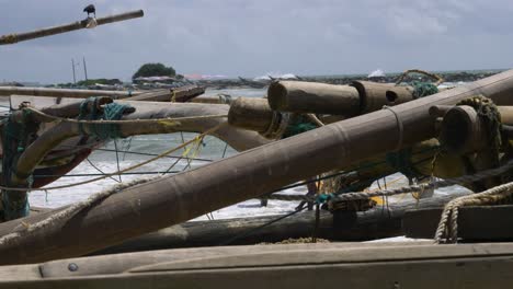 traditional wooden handmade oruwa, katamaran or fishing boat at the beach in negombo, sri lanka