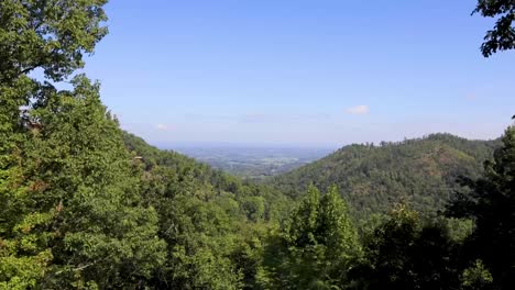 a sunny time-lapse on top of the mountain, overlooking the valley with clouds rolling in half way through