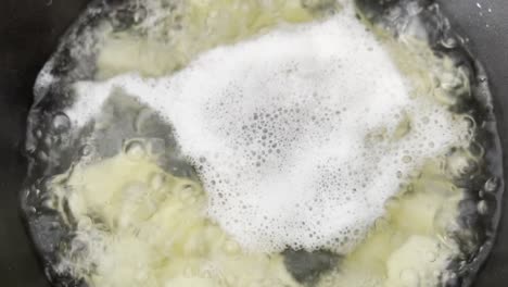 close-up-footage-of-potatoes-boiling-in-a-saucepan