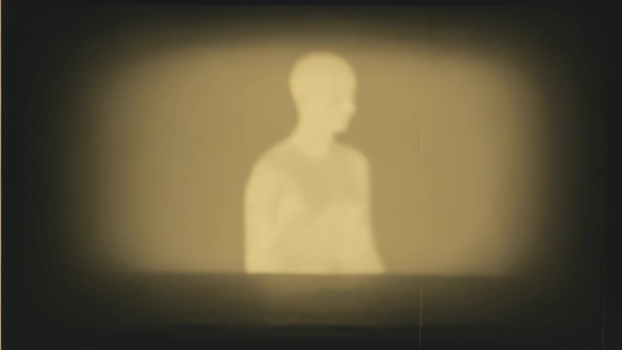 Turning man silhouette after projection start, turning head right behind low ledge with sepia grain