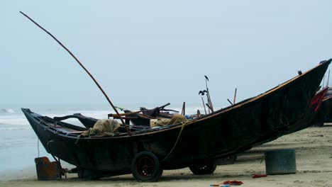 wooden fishing boat at the beach in bangladesh at monsoon stormy weather