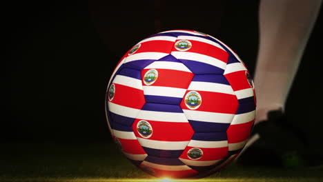 football player kicking costa rica flag ball