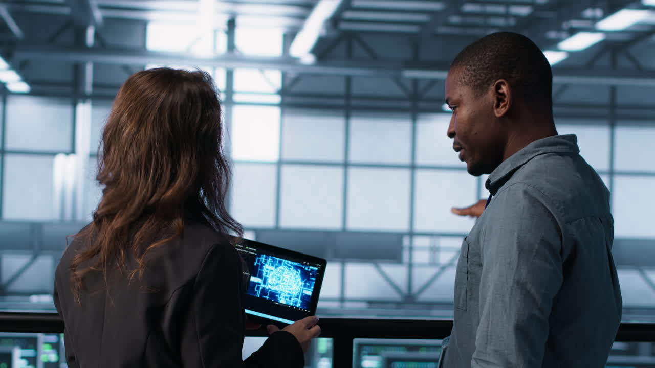 Teamworking server farm employees using AI on tablet