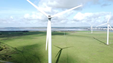 alternative green energy wind farm turbines spinning in frodsham cheshire fields aerial view rising