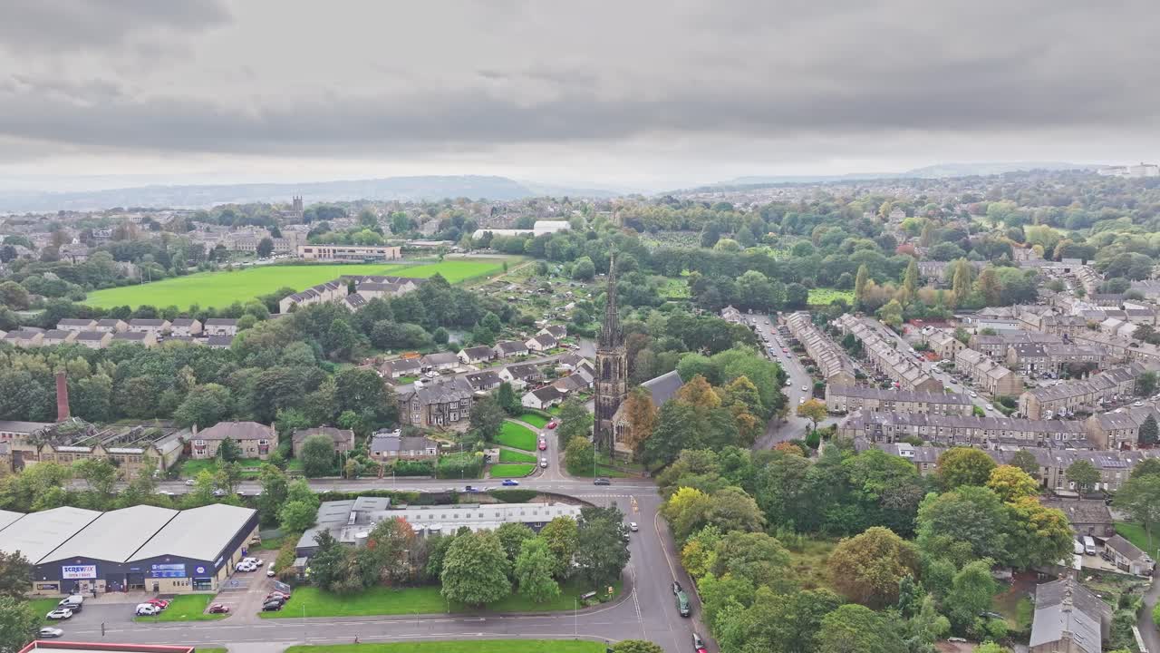 Drone rises above suburban neighborhood in Huddersfield England on cloudy day