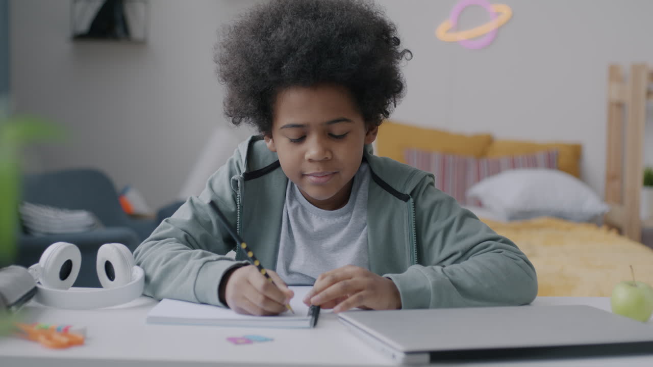 Child doing homework in bedroom