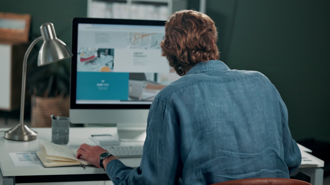 Man experiencing neck pain while working at a computer