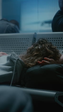 tired passenger napping in airport waiting area