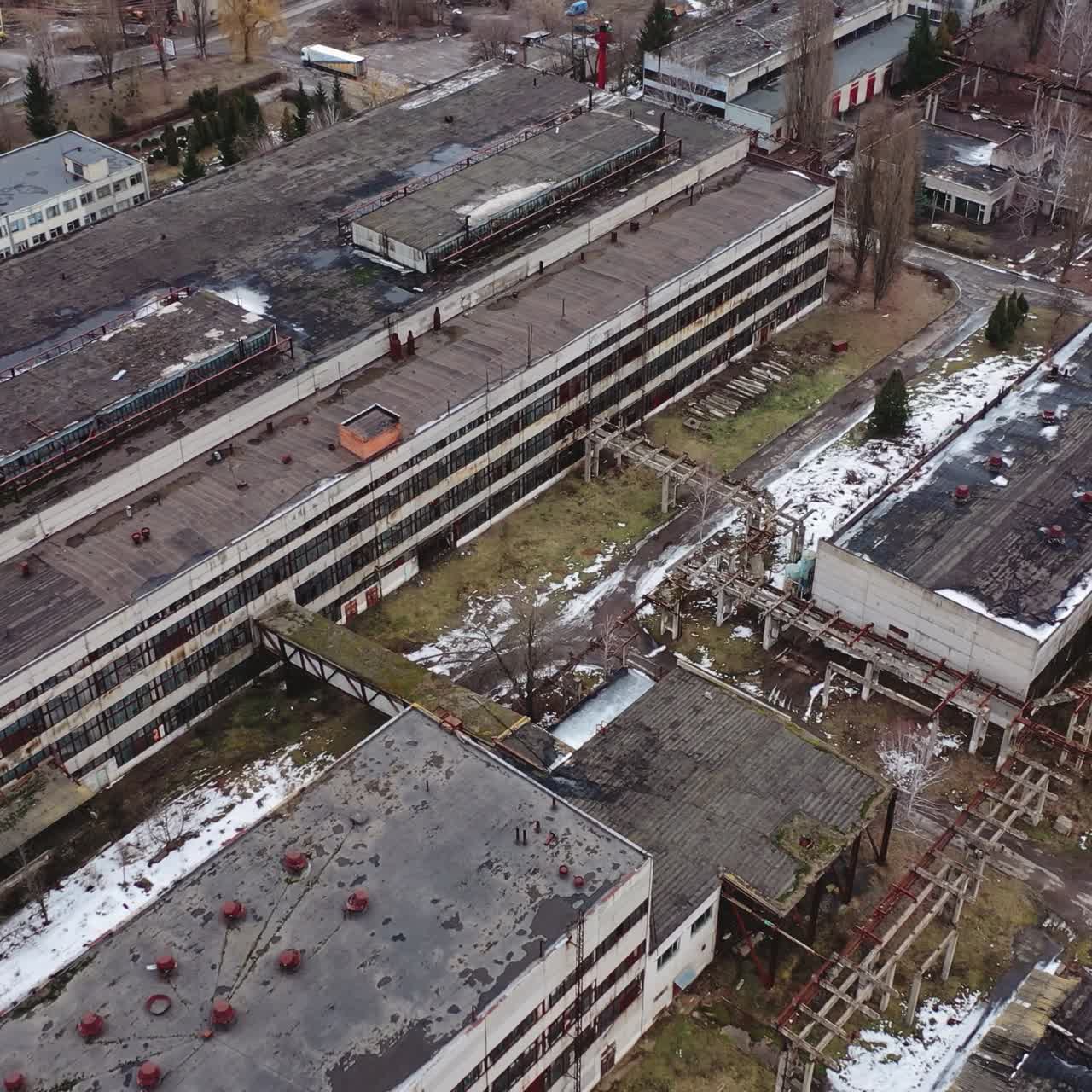 Old industrial zone with ruined buildings. Empty abandoned factory with brick edifices in place. Large aged enterprise. Top view