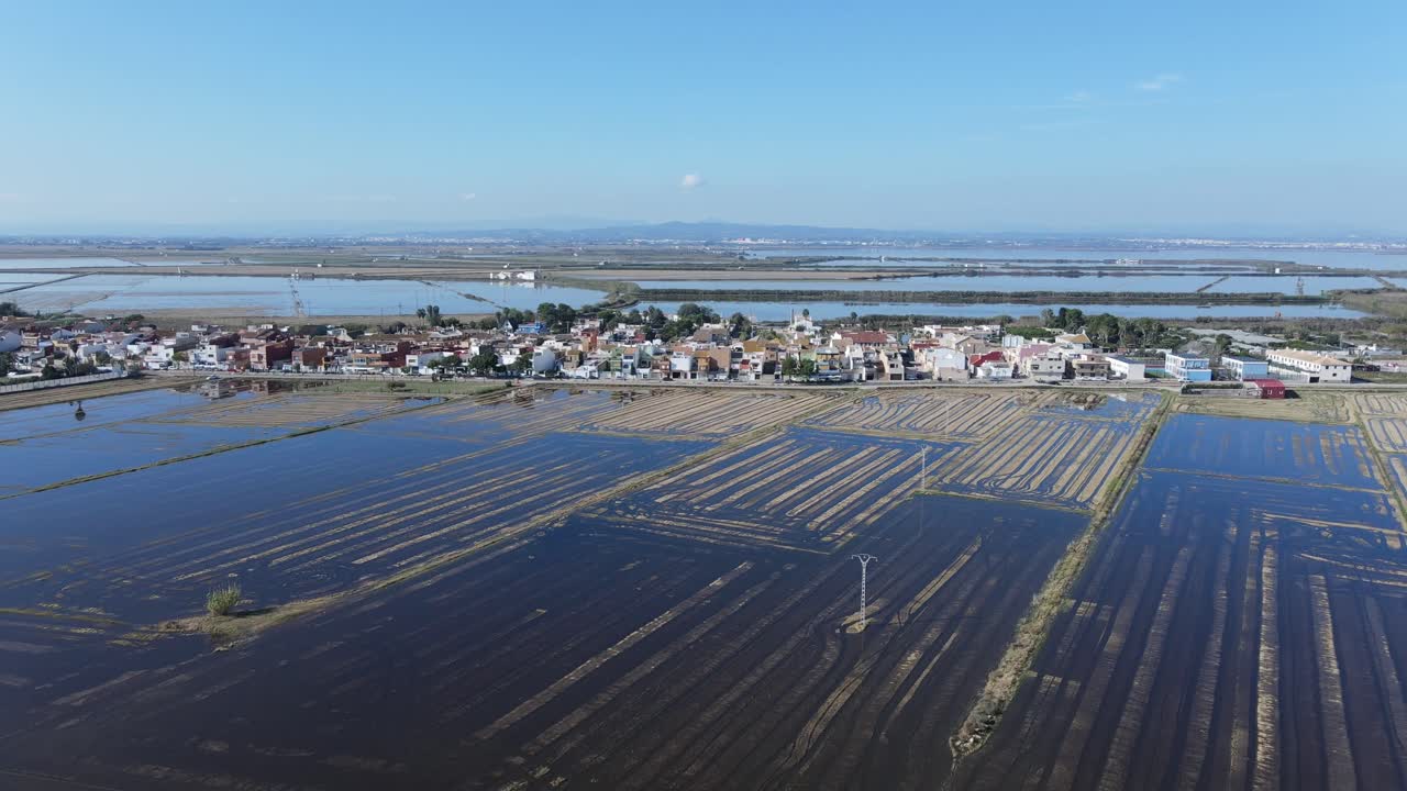 Aerial View of a Coastal Town and Rice Paddies