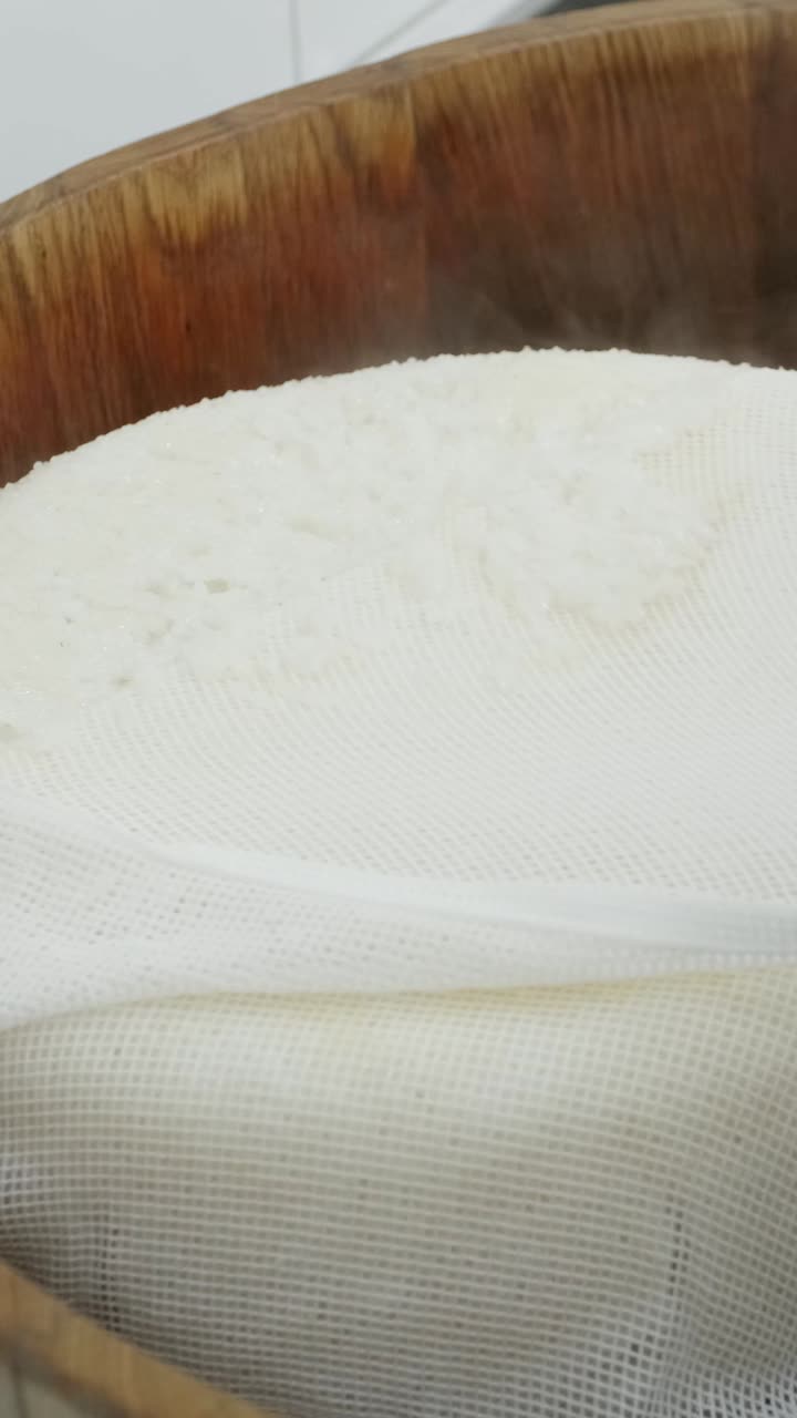 Steamed rice in a wooden bowl