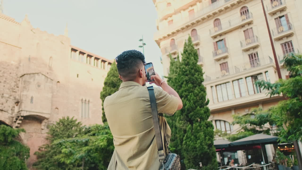 Man taking photo of a city building