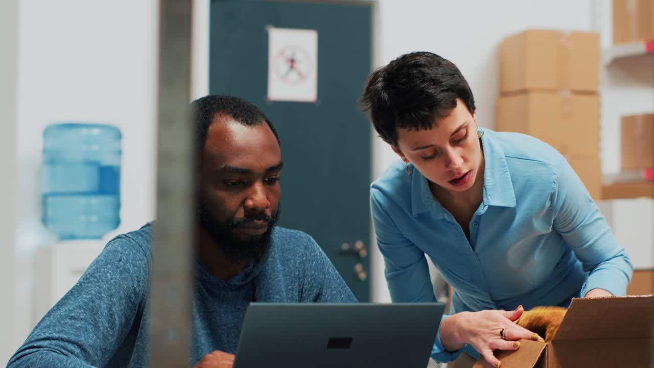 Employees Working in Warehouse with Laptop and Cardboard Boxes
