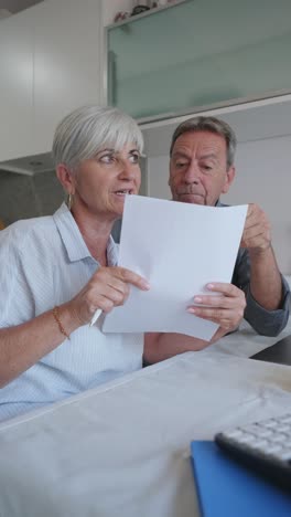 senior couple reviewing paperwork at home