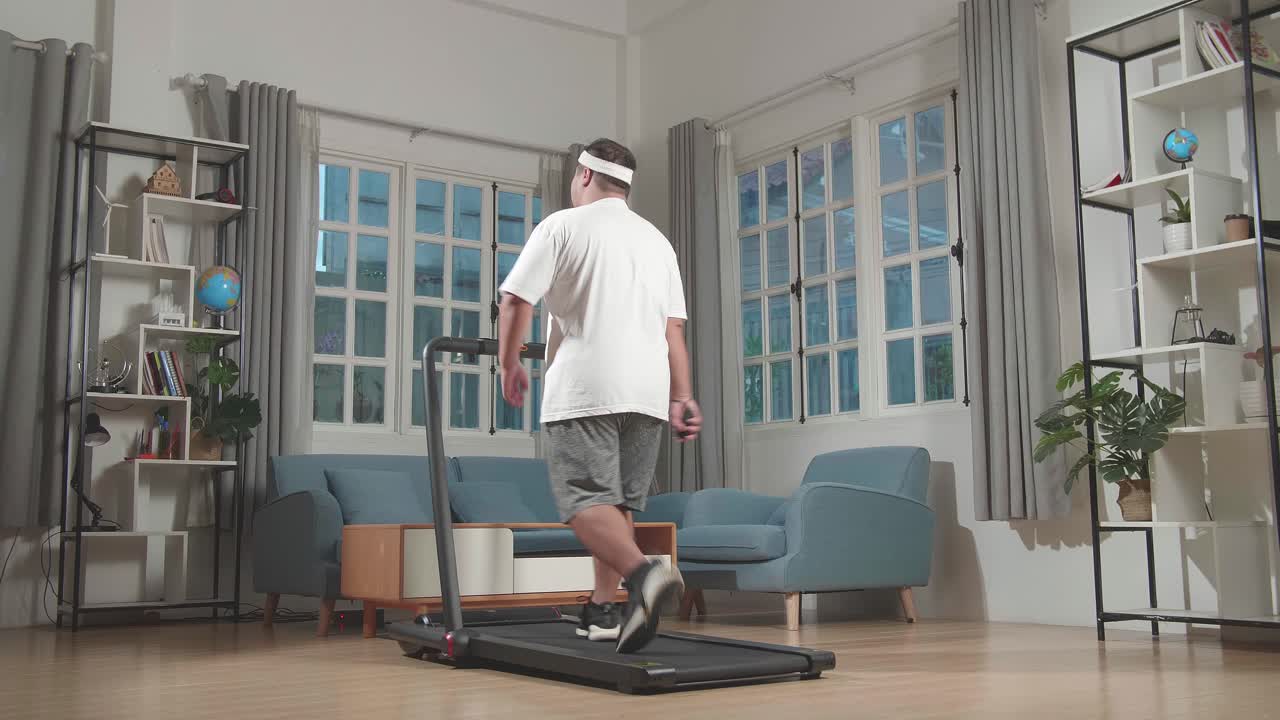 Man Walking on Treadmill at Home