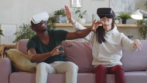 young couple enjoying augmented reality with vr headsets