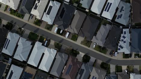 aerial top down shot over australian residential area with modern solar panels in roof in perth city, australia